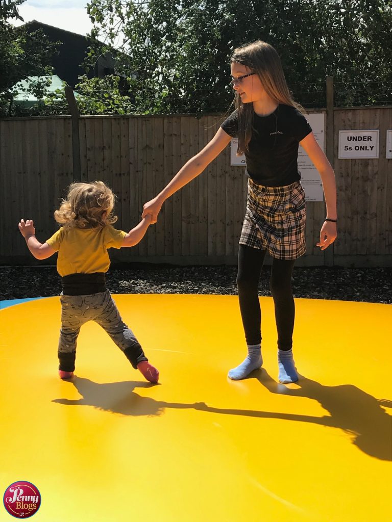 Two children on the jumping pillow at Woodside Animal Farm