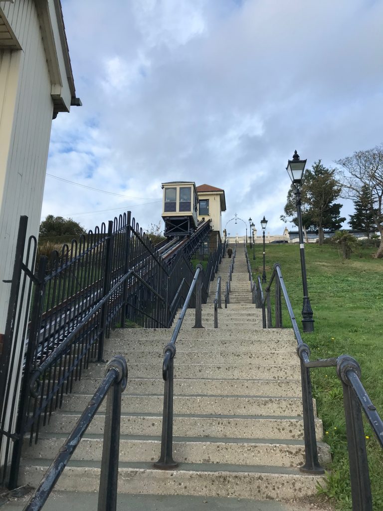 A view up the tracks of the Southend cliff lift, taken from just outside the lower station and looking up the steps that run next to the tracks.
