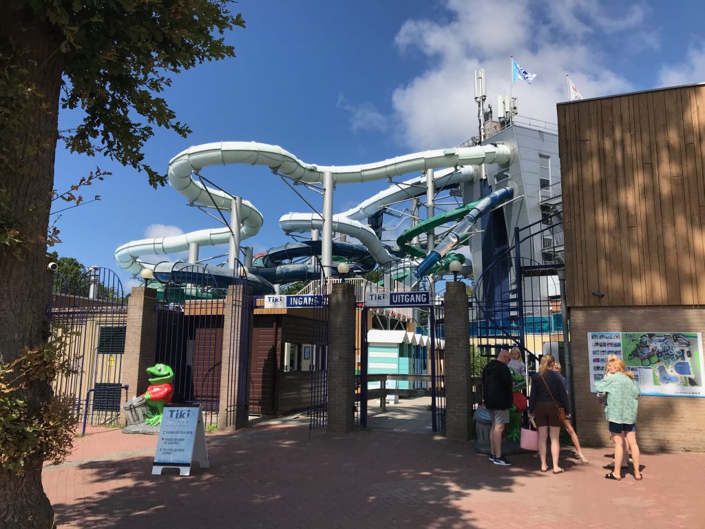 The entrance to the outdoor Tiki pool at Duinrell with the indoor pool's slides visible in the background.