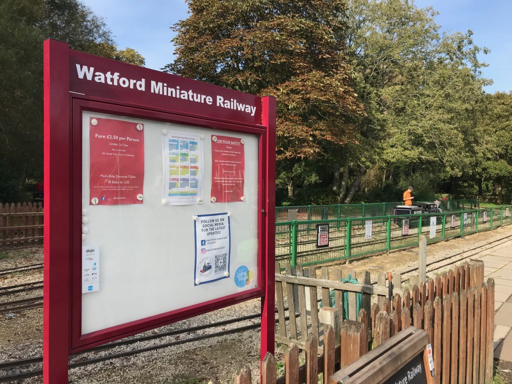 A notice board at Watford Miniature Railway and a view towards the platform area