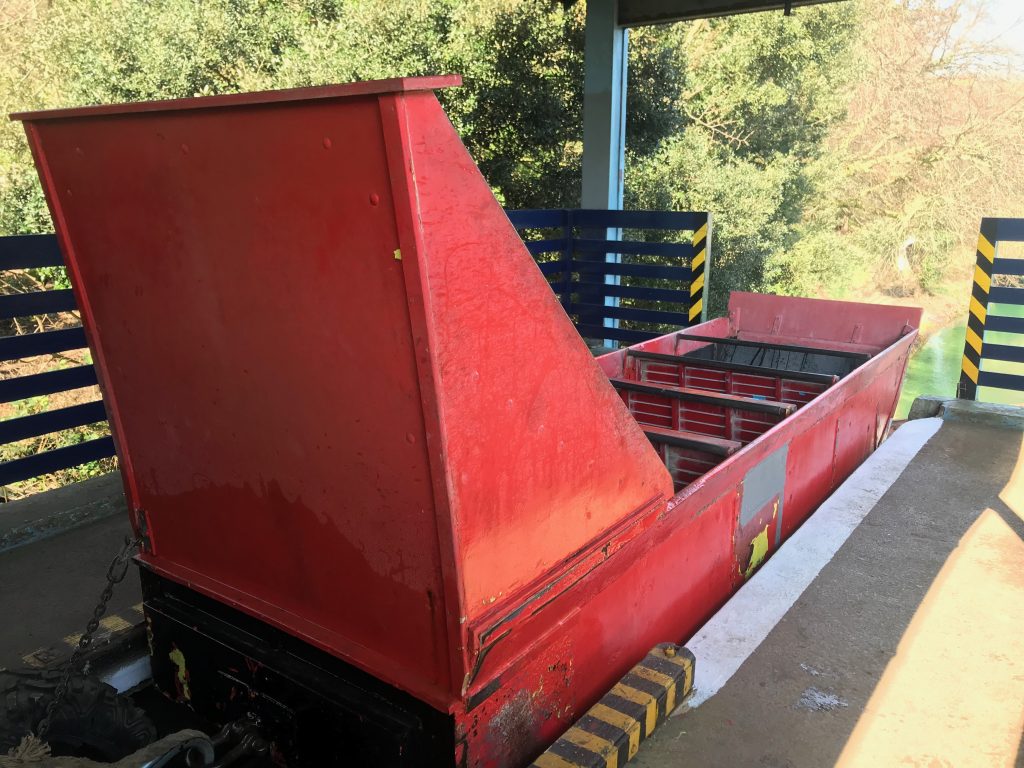 The red boat part of the water chute which looks a bit like a basic sleigh that Father Christmas might ride in. This is taken at the top of the water chute and you can see the gap in the barriers where the boat will pass through to go down the metal ramp into the lake below.