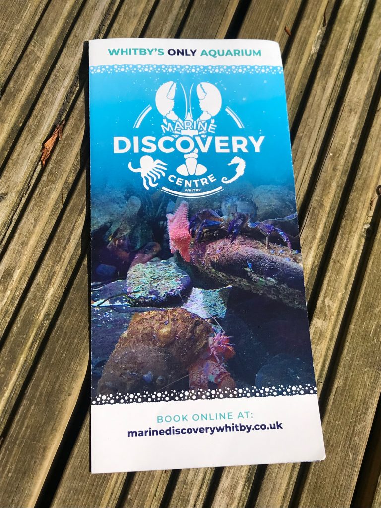 A visitor leaflet for the Marine Discovery Centre Whitby. At the top of the leaflet it says Whitby's Only Aquarium and their website URL is at the bottom with a statement saying "book online at:"